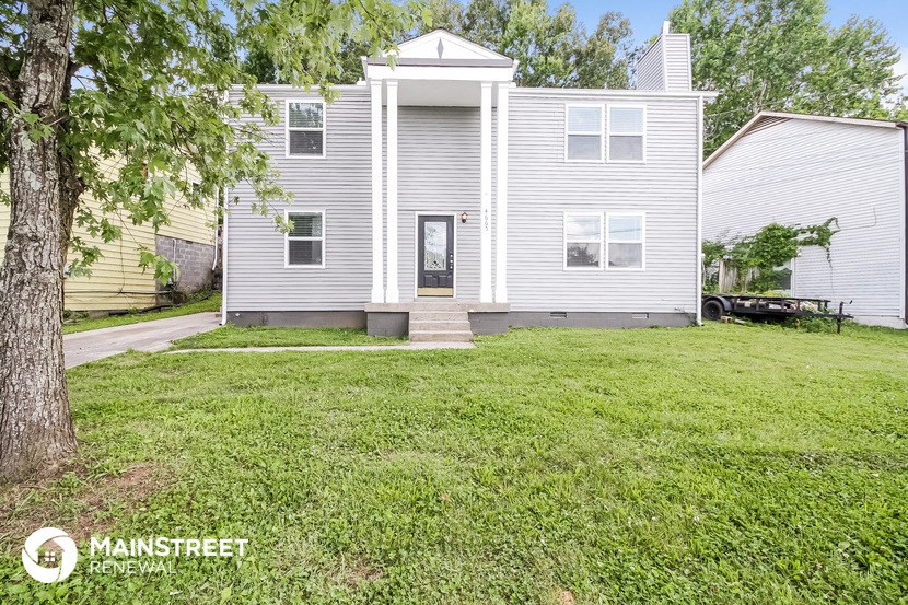 a white house with a yard in front of it