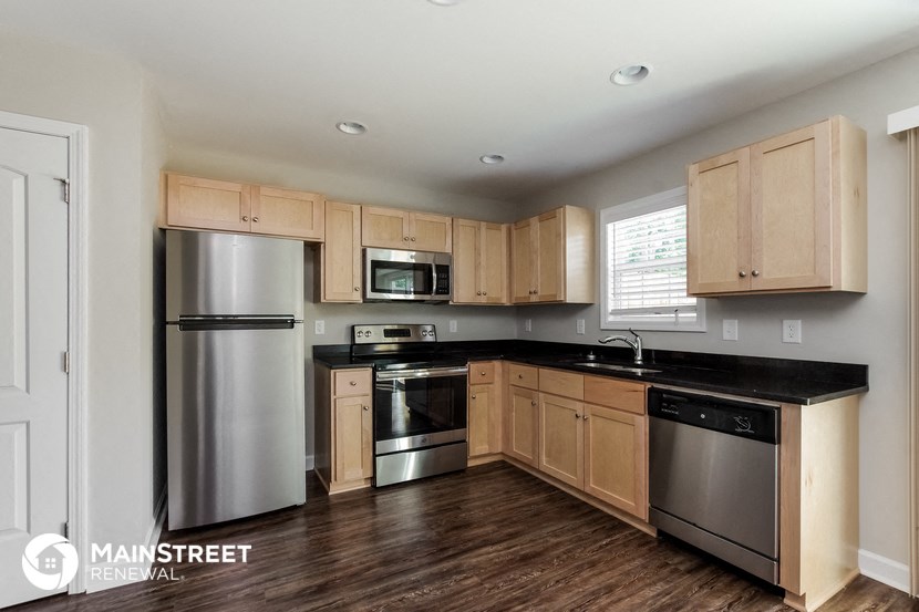 a kitchen with wooden cabinets and stainless steel appliances