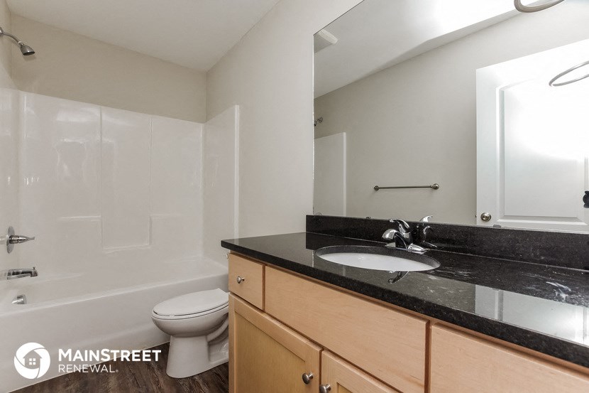 a bathroom with a sink and a toilet and a shower