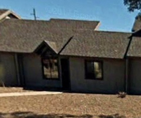 the front of a house with a gray roof