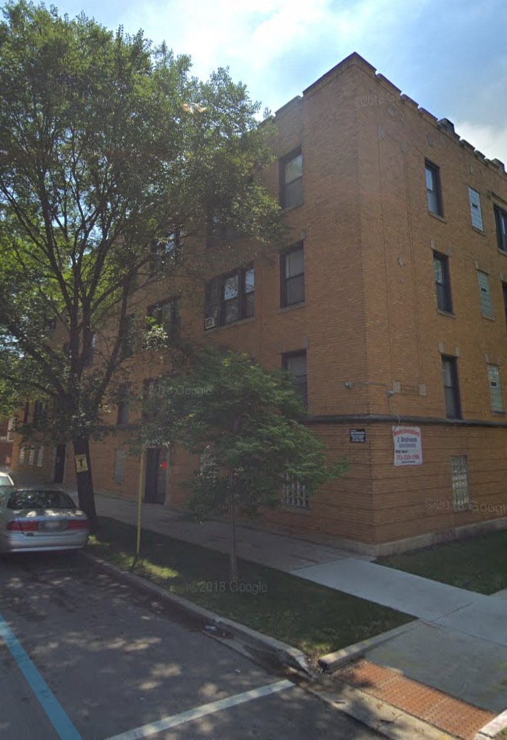 an apartment building on the corner of a street
