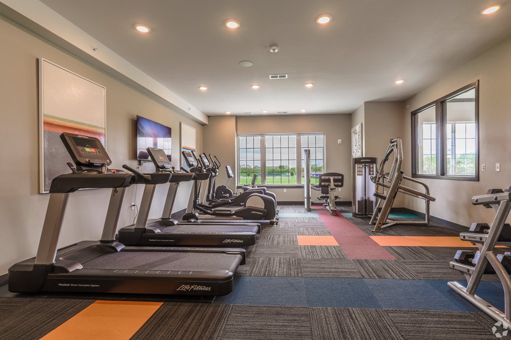 a gym with treadmills and cardio equipment at the flats at 3600 apartments