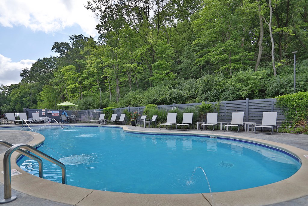 a swimming pool in front of an apartment building
