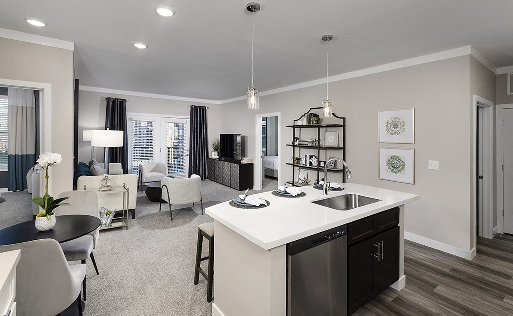 an open concept kitchen and living room with a white counter top
