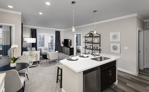 an open concept kitchen and living room with a white counter top