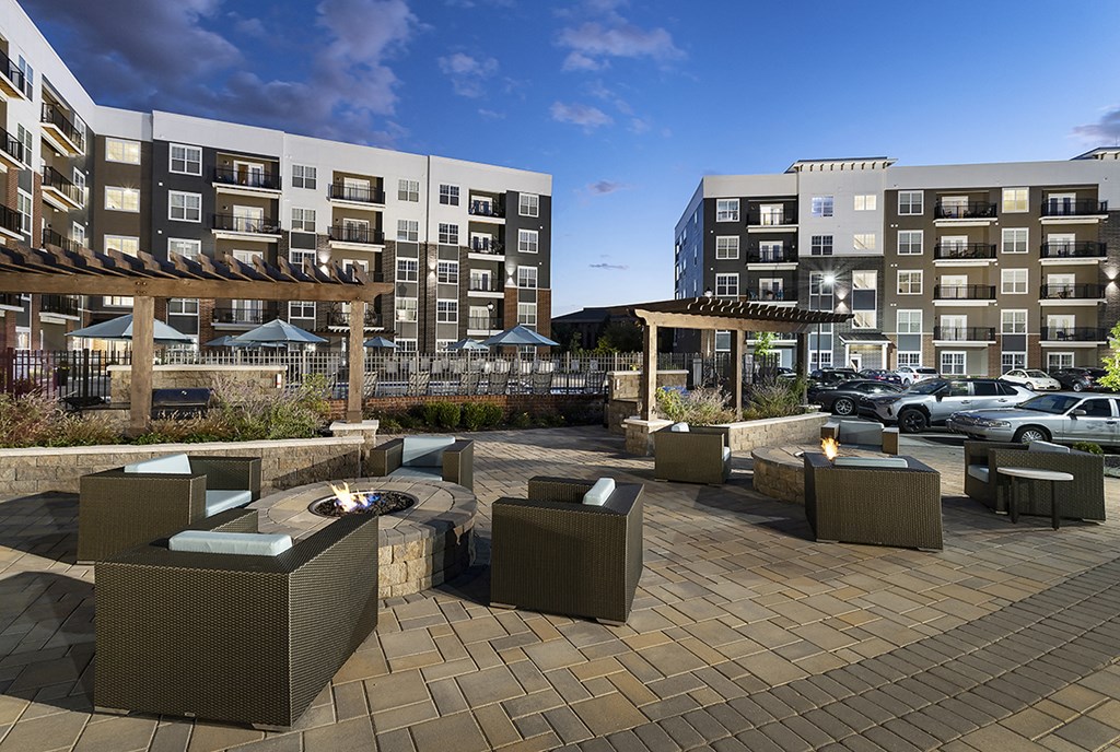 a rendering of an outdoor patio with chairs and a fire pit