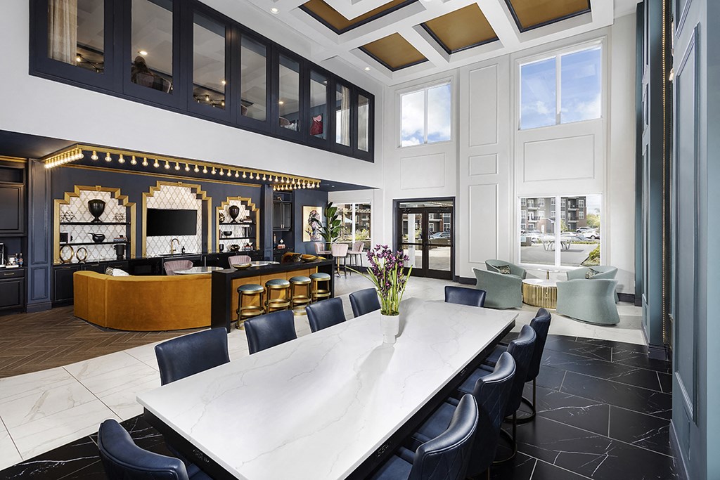 a dining room with a long white table and chairs