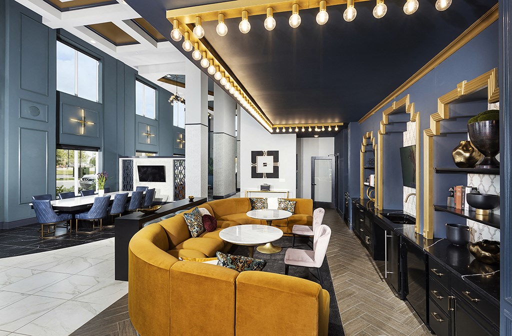 a living room with blue walls and a yellow couch and tables