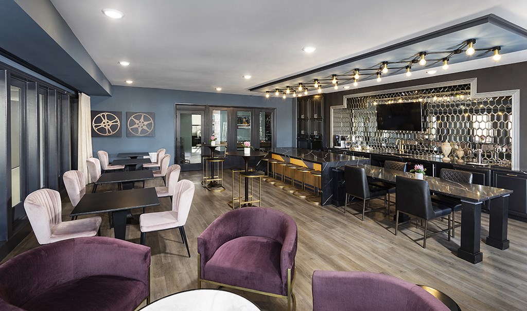 a dining room with tables and chairs and a bar