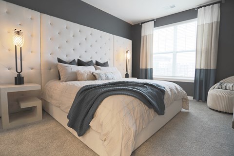 a bedroom with a large bed and a window