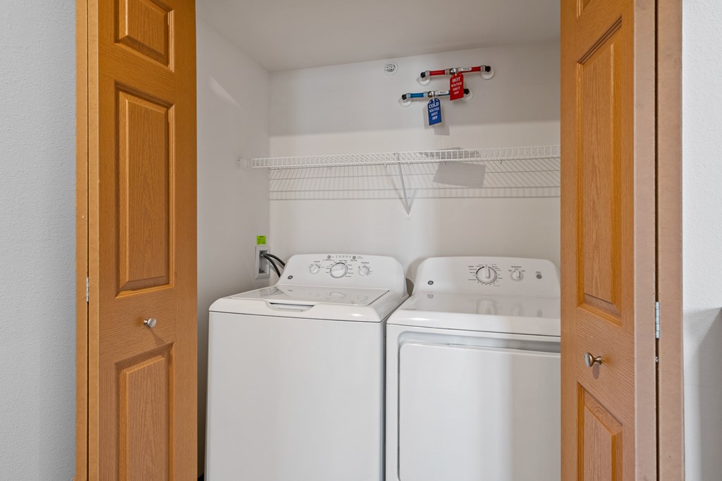 A small laundry room with a washer and dryer.