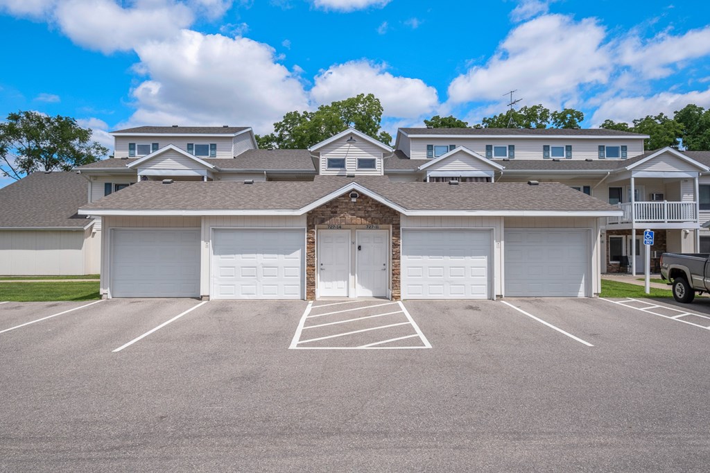 A large white garage door is in the center of a parking lot.