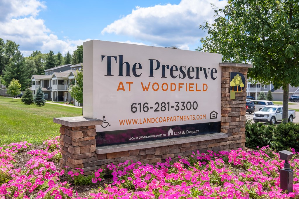 A sign for The Preserve at Woodfield with a phone number and website listed.