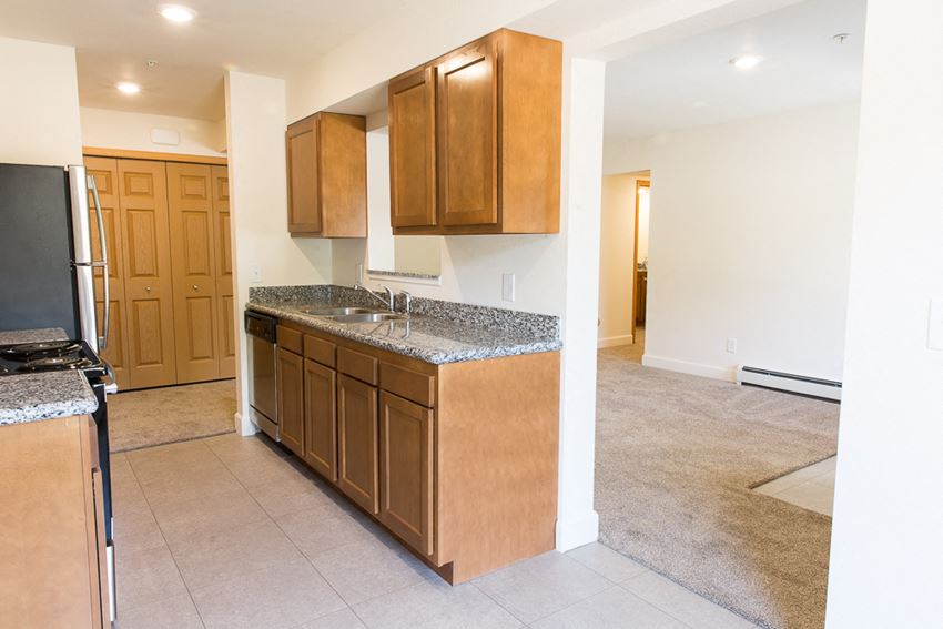 a kitchen with wooden cabinets and a counter top in a house