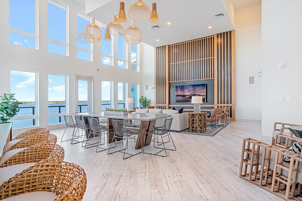 a large living room with tables and chairs and a fireplace