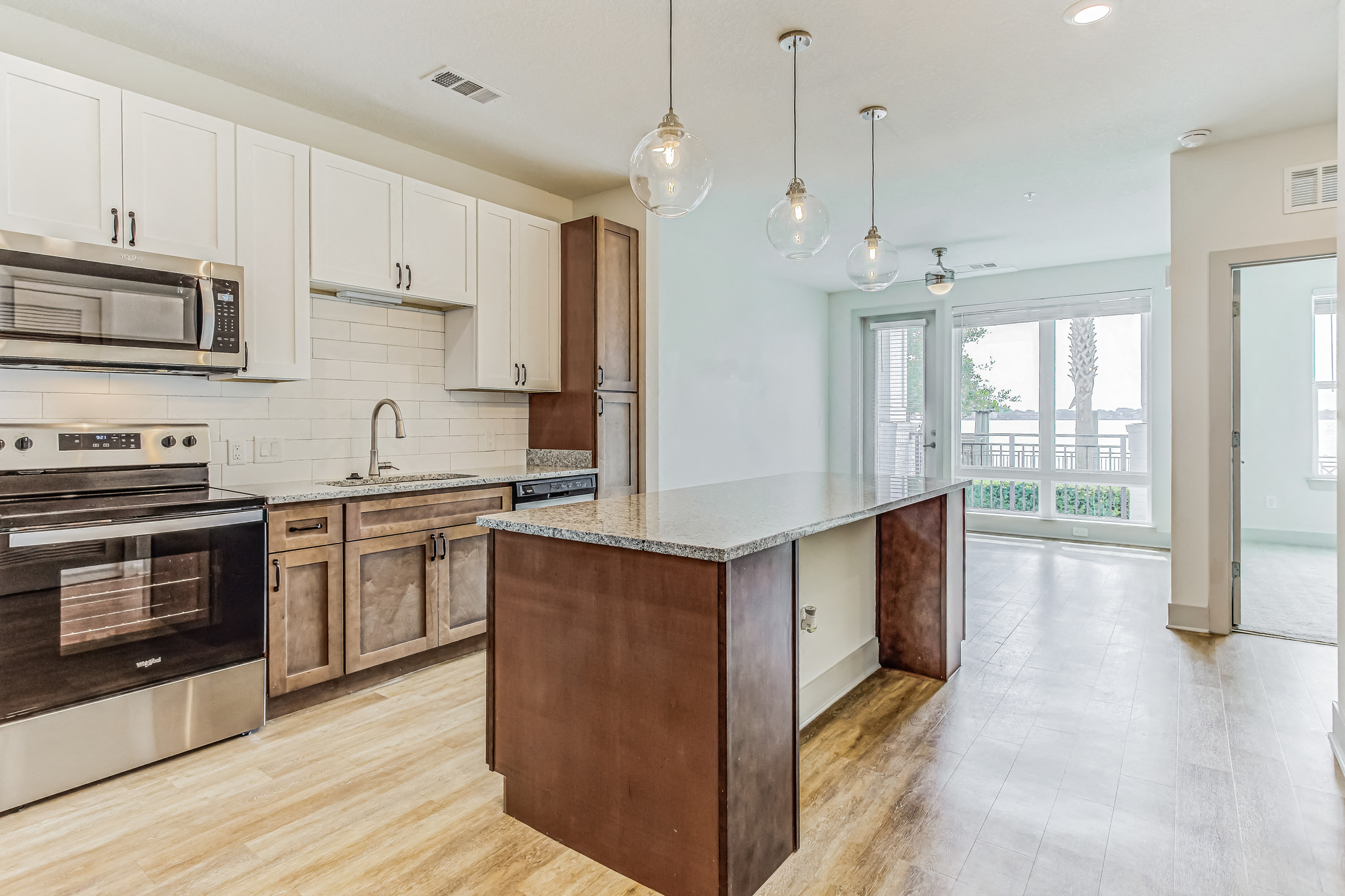 a large kitchen with an island and stainless steel appliances