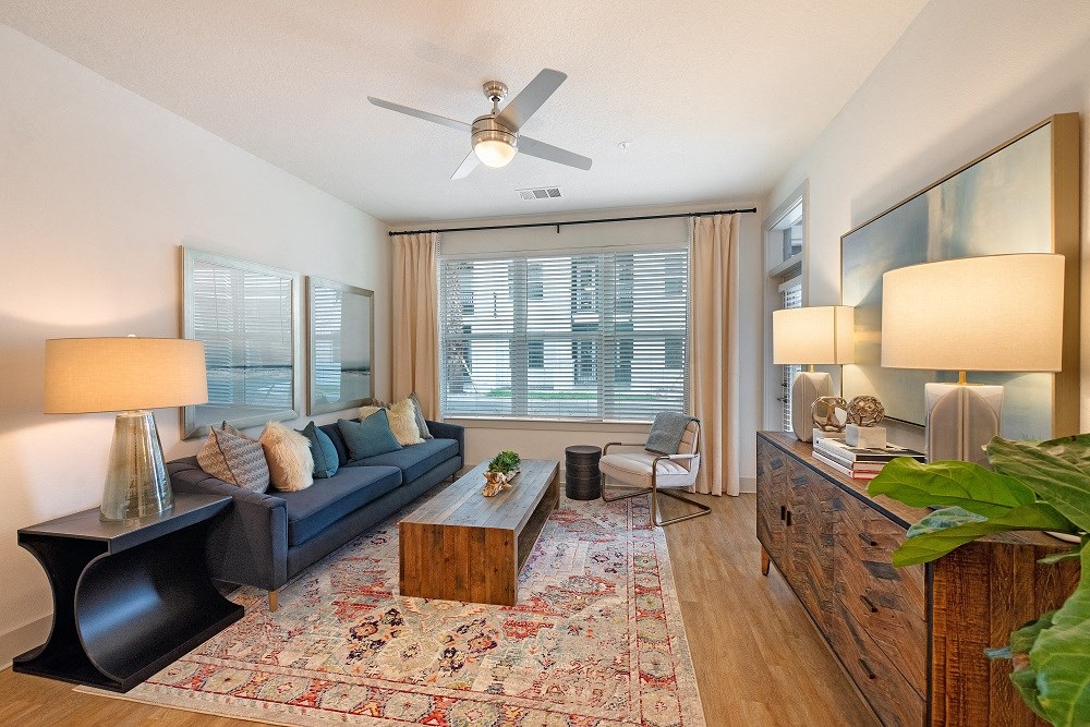 a living room with a couch and a ceiling fan