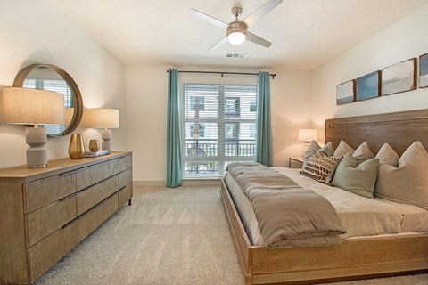 a bedroom with a large bed and a ceiling fan