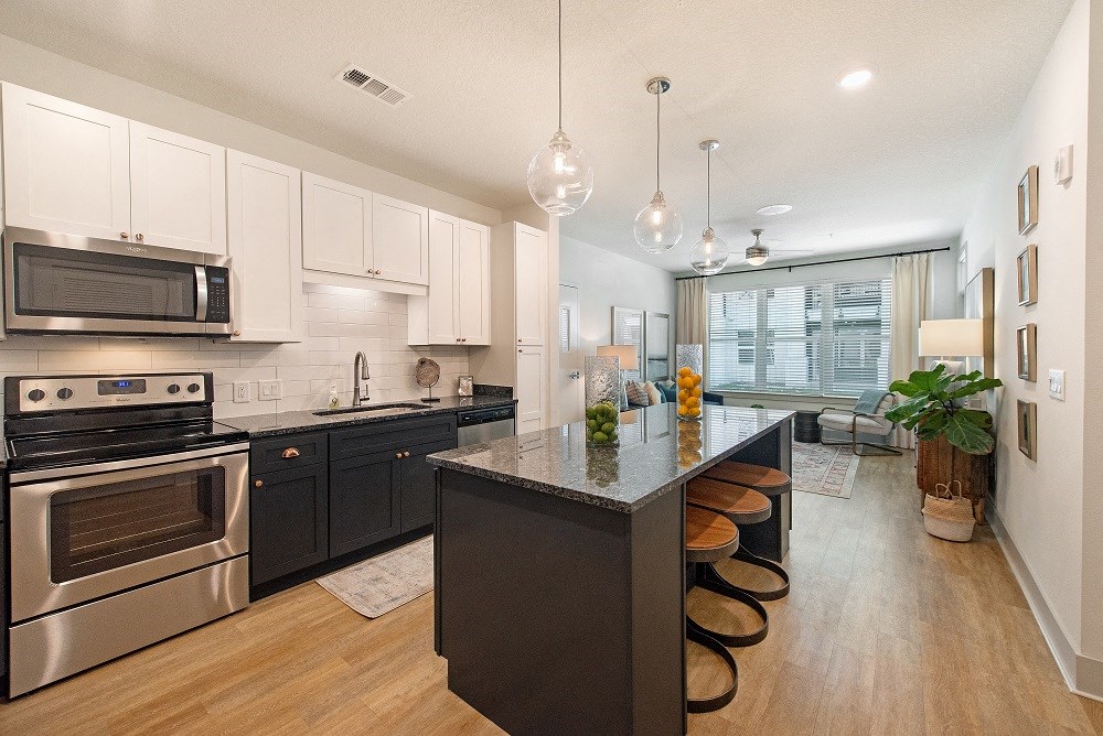 a kitchen with stainless steel appliances and an island with stools