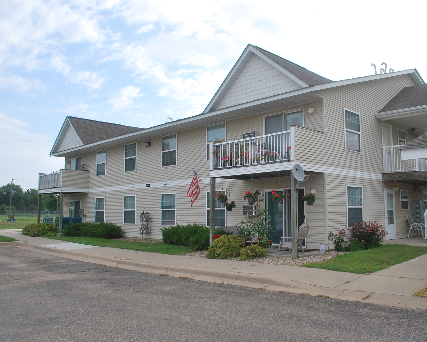 a house with a porch and an flag on the balcony