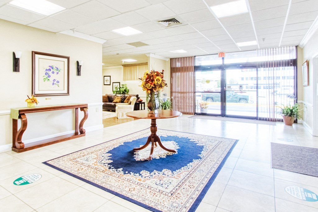 lobby with beautiful flower arrangement on table in entranceway