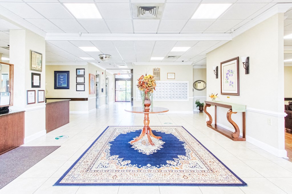 lobby with flower arrangement, reception desk, and mailboxes