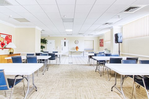 folding tables sand chairs in large room
