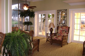 comfortable sitting area beside windows and door to outside
