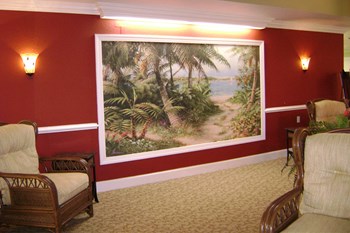 sitting area with massive painting of tropical scenery