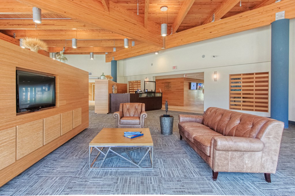 Couch, coffee table, and TV in lobby at St. Giles Manor