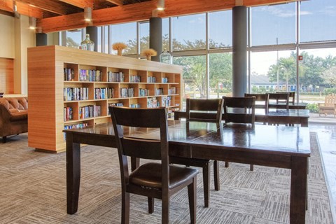 a dining room with a table and chairs and a library