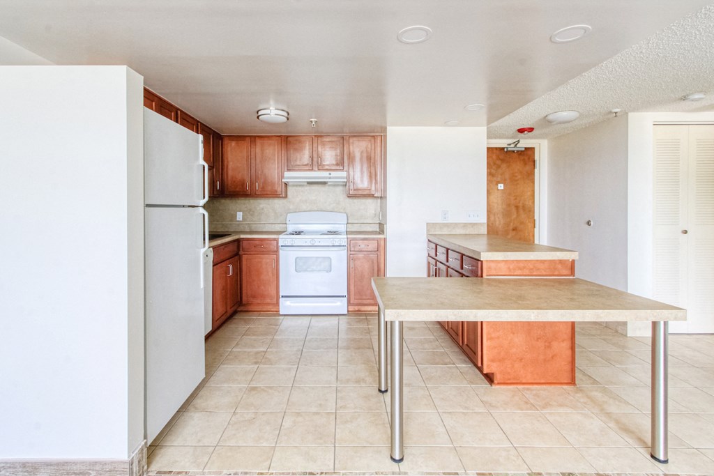 Kitchen2 kitchen with efficient appliance package, ample cabinetry, and island