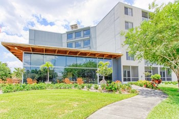 Outside1 lush landscaping and outdoor seating in front of large lobby windows - Photo Gallery 3