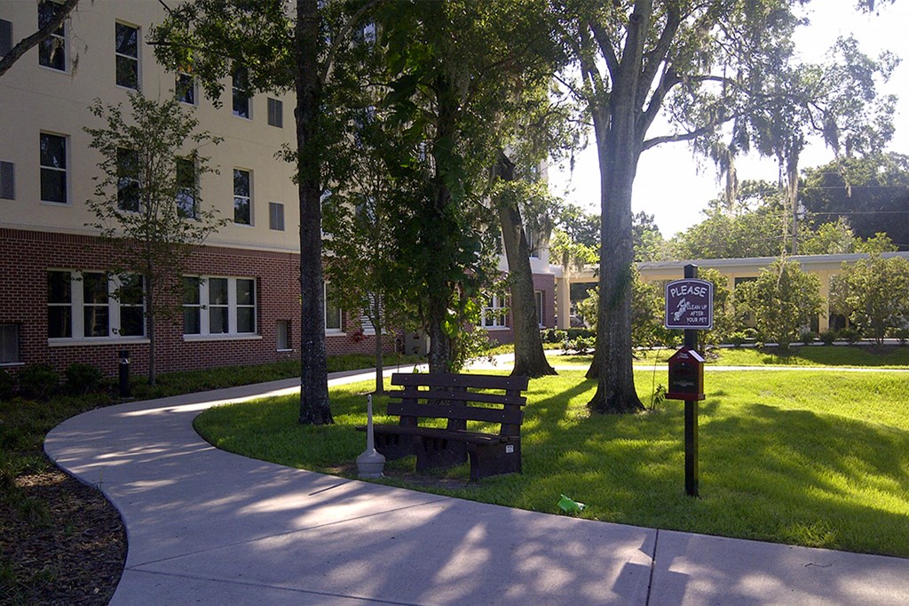 neat sidewalk and bench for resting in courtyard