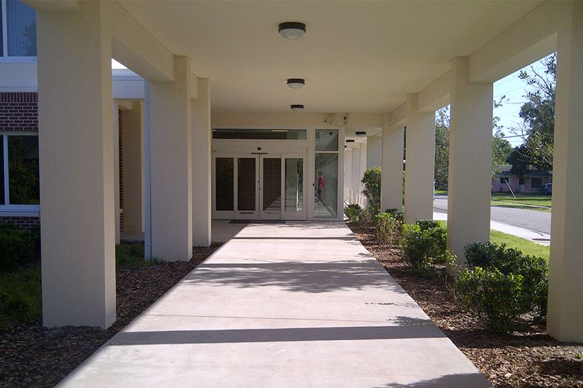 Entrance1 covered walkway with neat landscaping at St. Giles Manor II