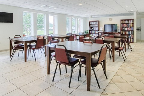a dining room with tables and chairs in a library