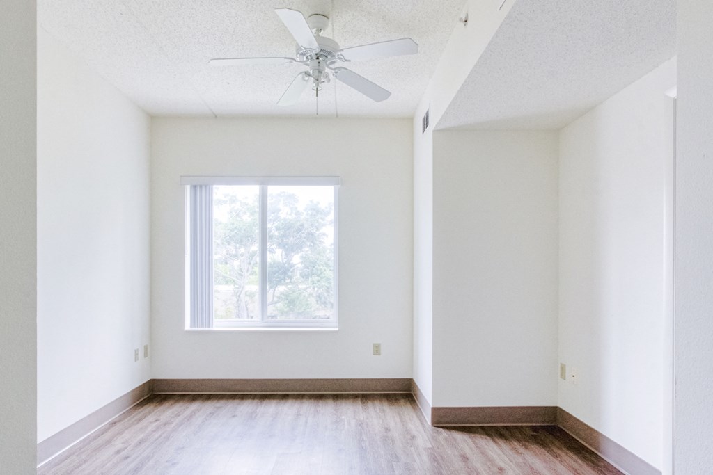 Bedroom with large window and ceiling fan