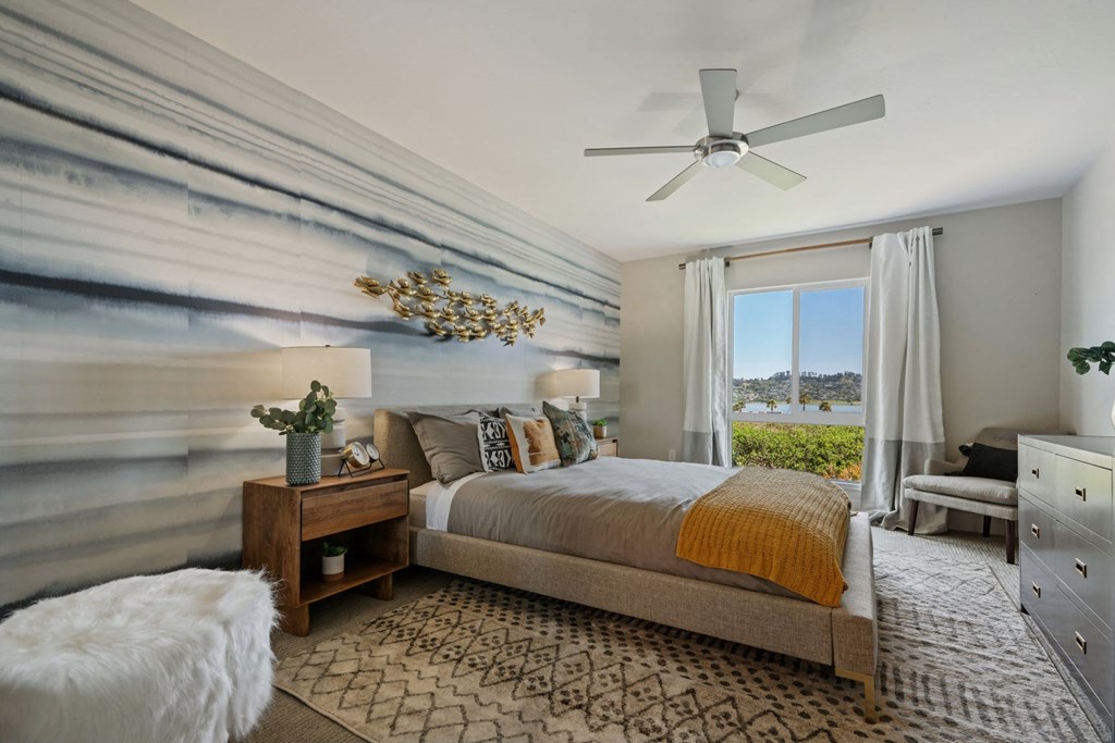 a bedroom with a bed and a ceiling fan
