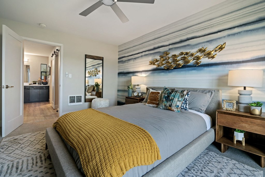 a bedroom with a bed and a ceiling fan