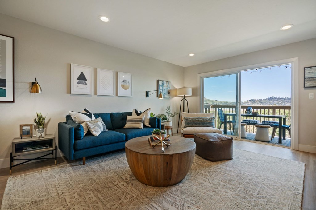 a living room with a blue couch and a coffee table