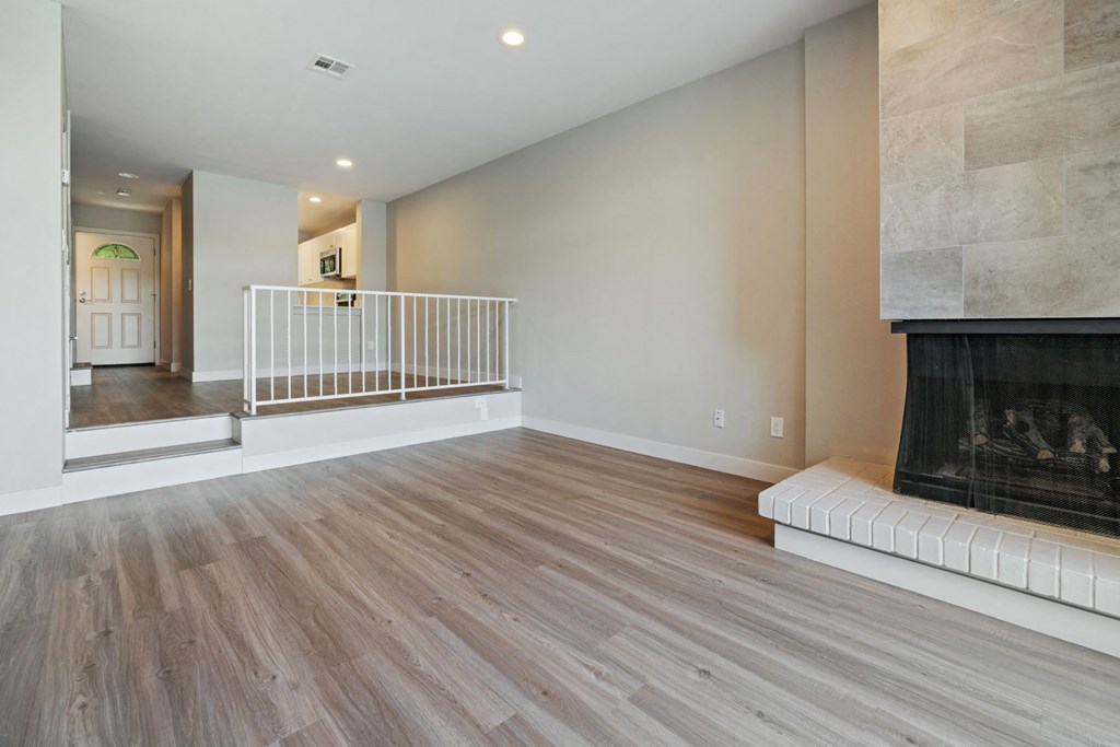 a living room with a fireplace and a staircase