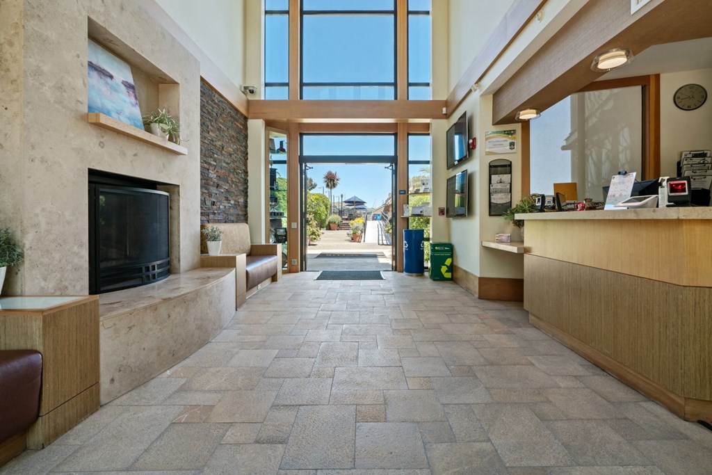 the lobby or reception area of a hotel with a fireplace