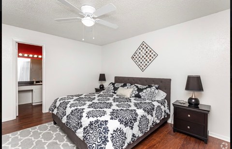 a bedroom with a bed and a ceiling fan
