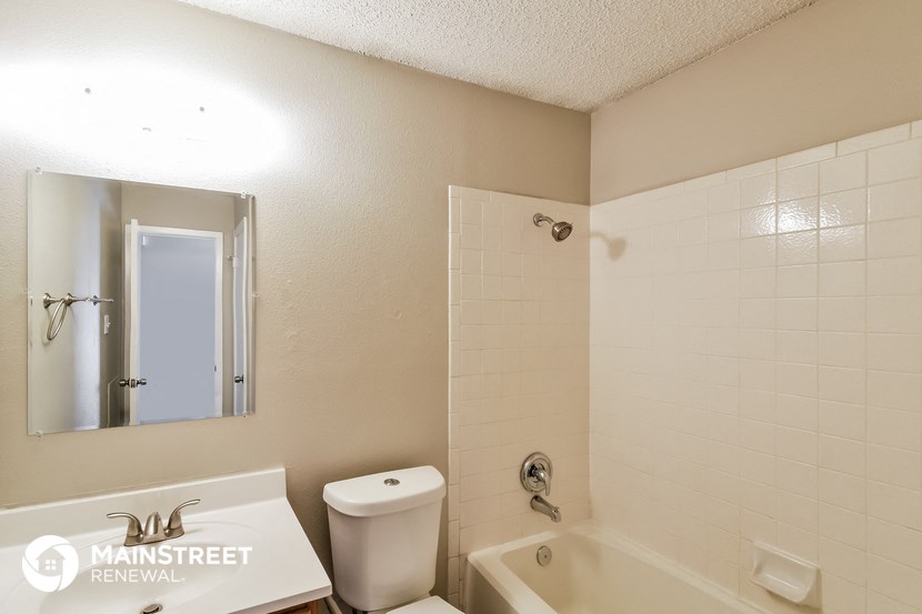 a bathroom with a tub and a toilet and a sink