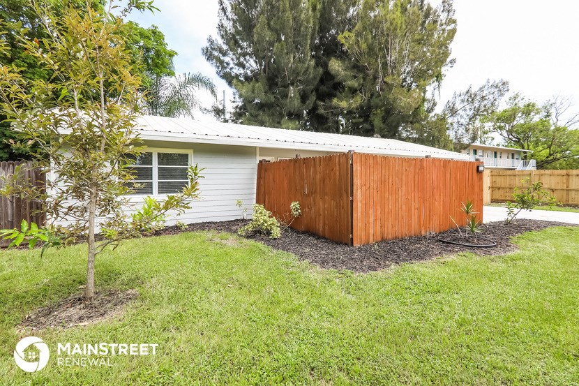 a wooden privacy fence in front of a house