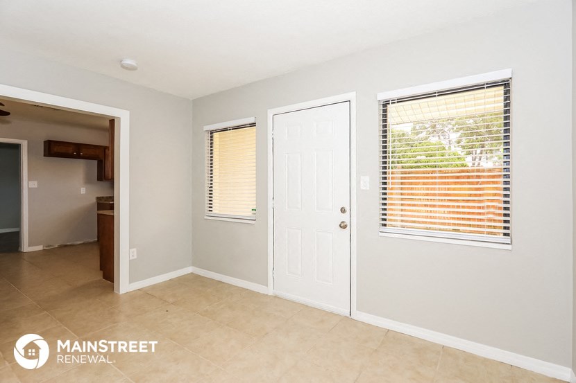the living room and backdoor to the kitchen