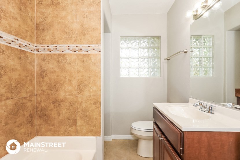 a bathroom with a toilet and a sink and a shower