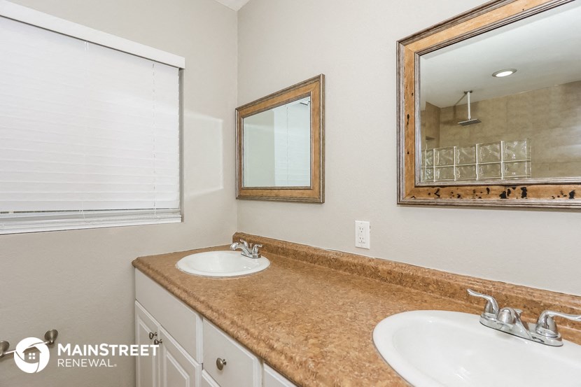 a bathroom with two sinks and a mirror