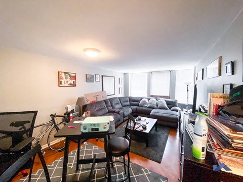 A living room with a grey couch and a black coffee table.