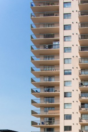 a swimming pool with an apartment building in the background